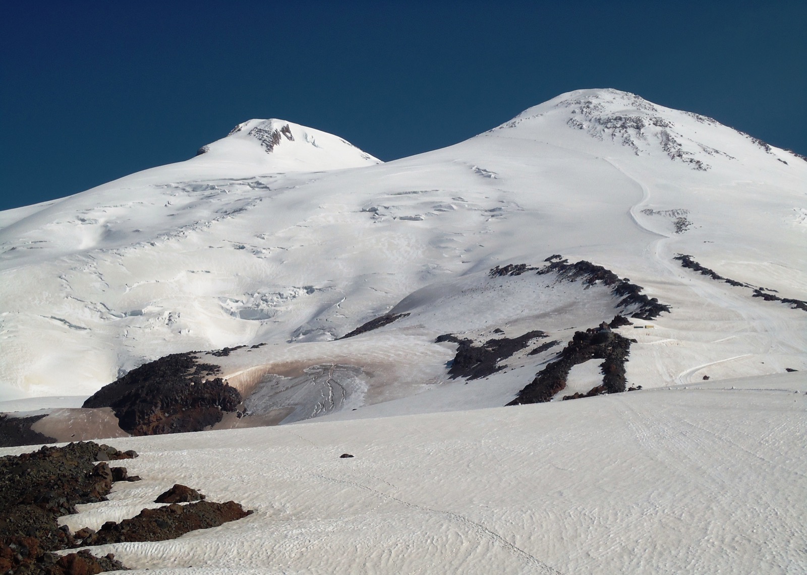 Elbrus from the south-east: the normal route the Defender was taken up runs from Priyut 11 past the Pastukhov Rocks to the saddle between the two summits, the eastern summit on the right.