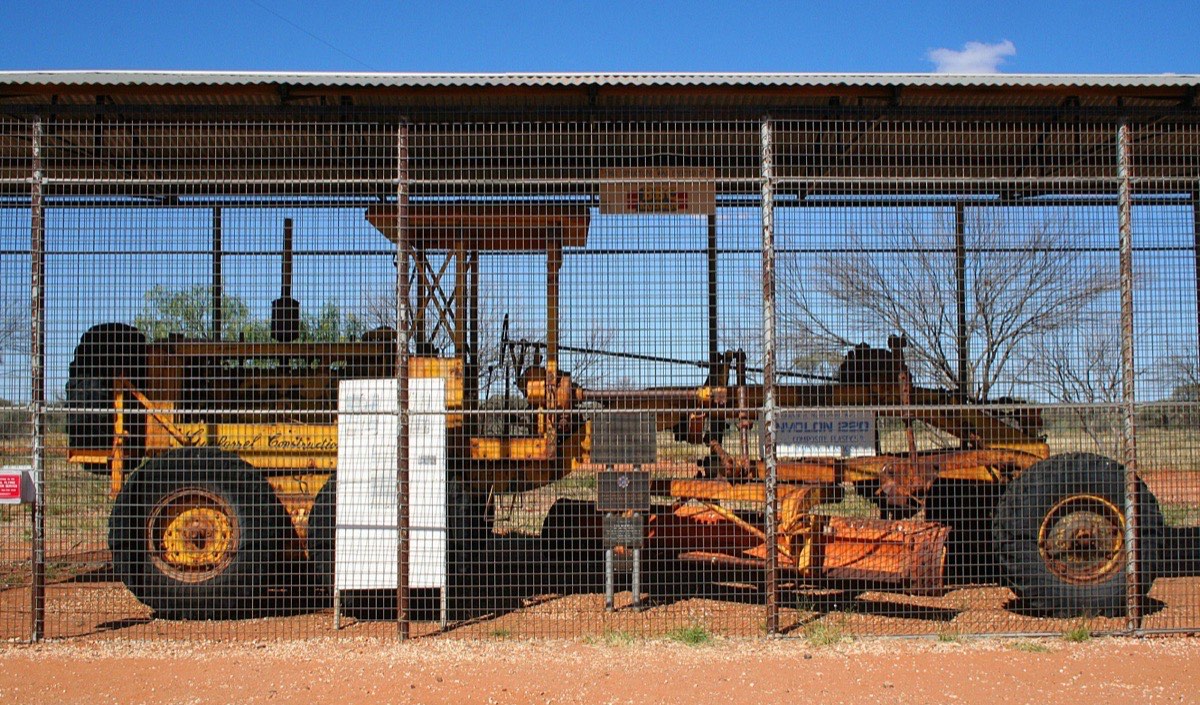 The party's Caterpillar No. 12 grader in its preservation cage at Giles Weather Station, where Beadell drove it in 1988.
