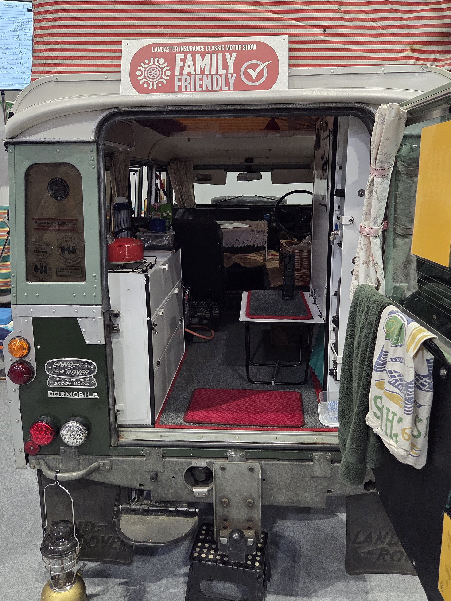 Series II 109 Dormobile — Rear view of a Land Rover Dormobile camper showing the side-hinged roof and striped fabric, Classic Motor Show, NEC Birmingham, 2025
