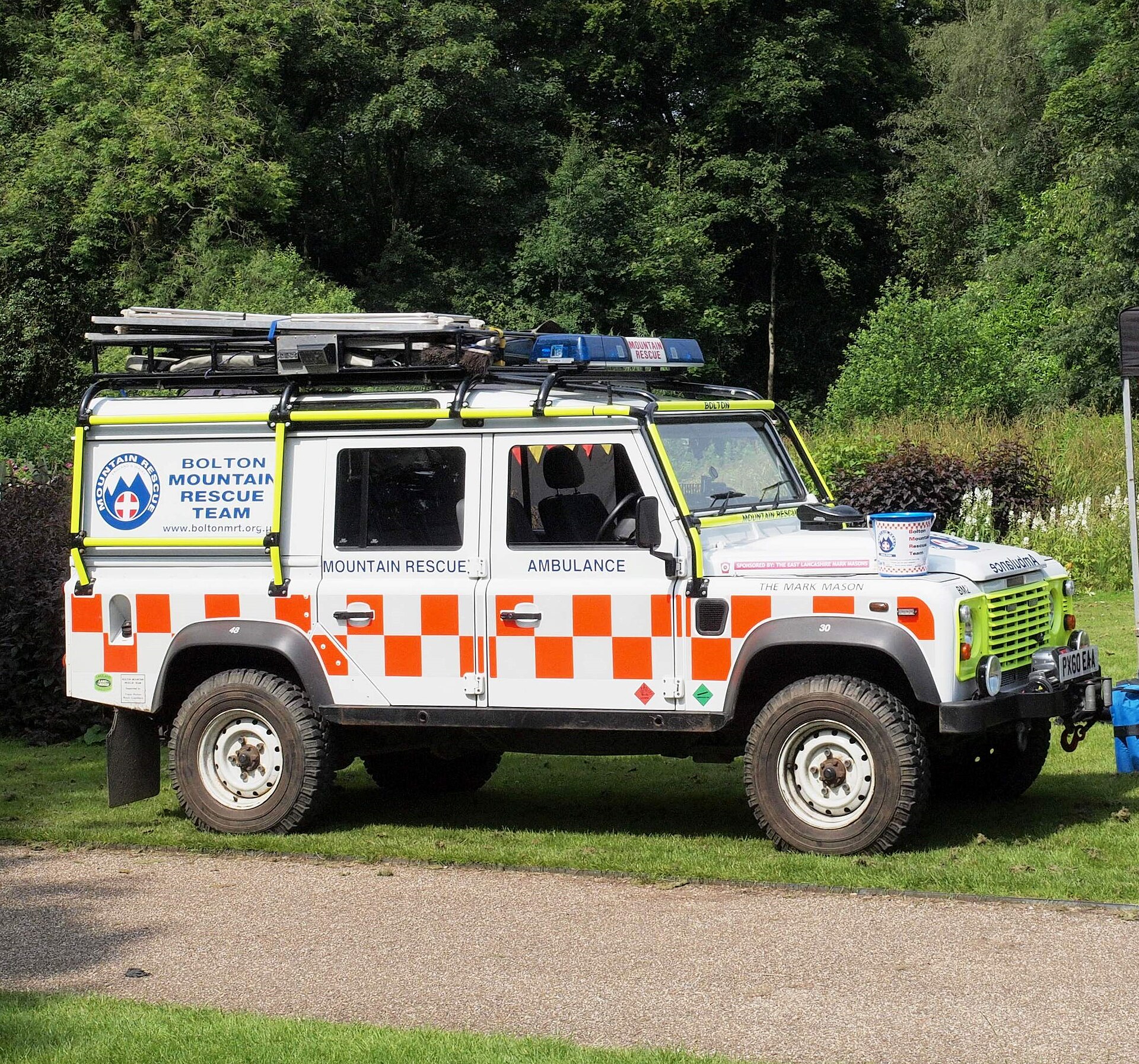 Mountain Rescue Defender 110 — Bolton Mountain Rescue Team Defender 110 rescue ambulance in the standard MREW white-and-orange livery - the same convention worn by the Dartmoor teams' vehicles