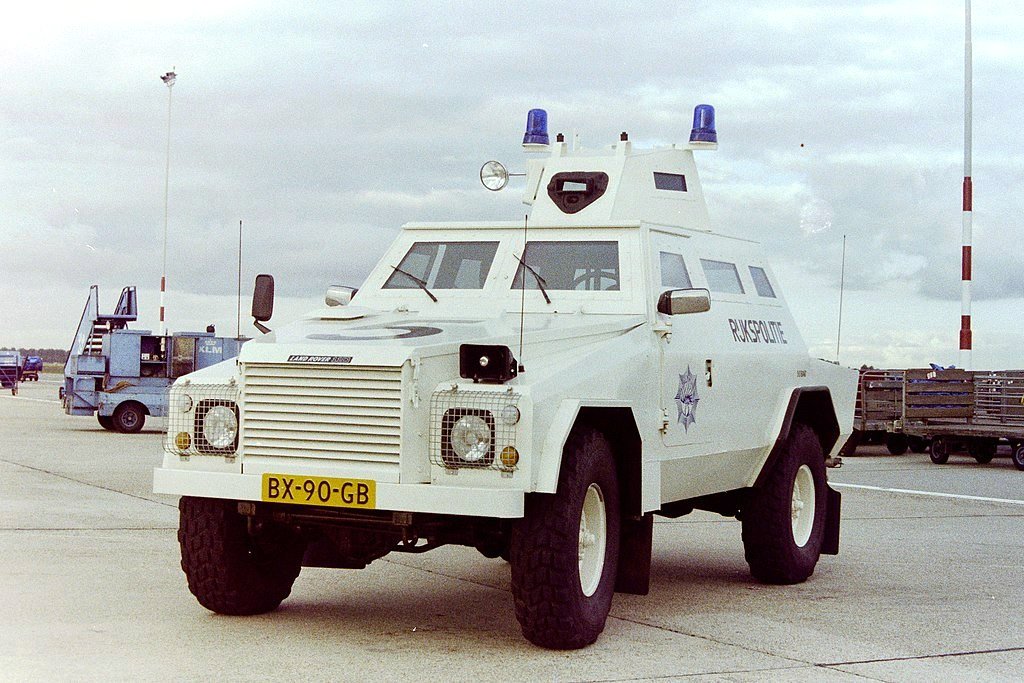 Shorland S54 Anti-Hijack — White Series 5-bodied Shorland of the Netherlands Rijkspolitie at Amsterdam Schiphol, May 1991, with blue beacons, a glazed cupola and a dark front aperture — the configuration and livery described for the S54 anti-hijack vehicle, though the photograph is not captioned with that designation